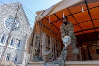 Soldiers from the 1231st Transportation Company, 1st Platoon, Missouri Army National Guard, load donated groceries from local neighborhoods onto Humvees at Aligned Media, St. Louis, Missouri, May 2, 2020. The groceries were donated to support local food banks. (U.S. Air National Guard photo by Senior Airman Audrey Chappell)