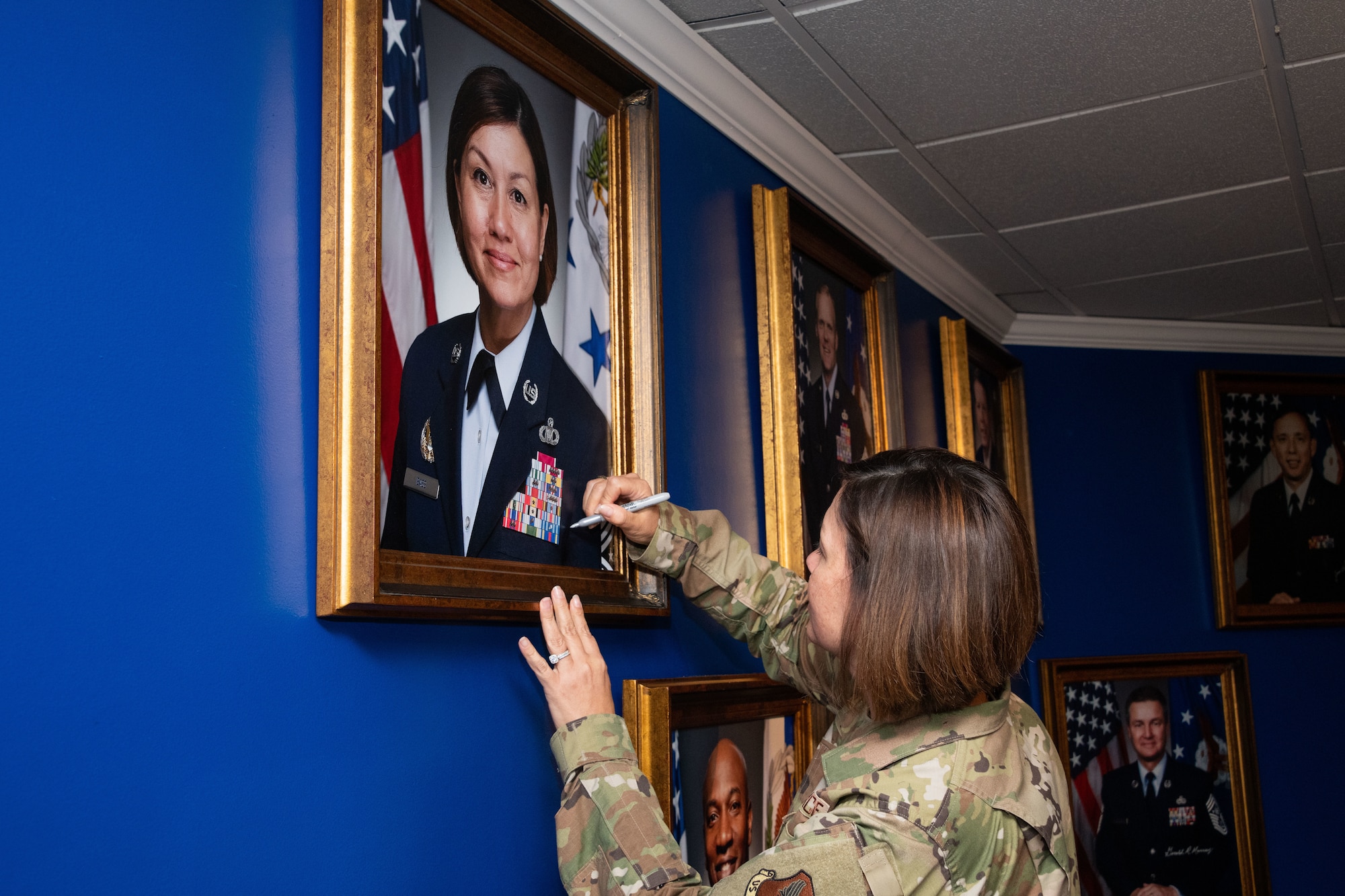 Chief Master Sgt. of the Air Force JoAnne S. Bass visits the Enlisted Heritage Research Institute to view and sign her official photo Sept. 23, 2020, on Maxwell Air Force Base's Gunter Annex. While visiting AU, Bass spoke with AF First Sergeant Academy students and shared her priorities; people, readiness and culture. (US Air Force photo by Cassandra Cornwell)