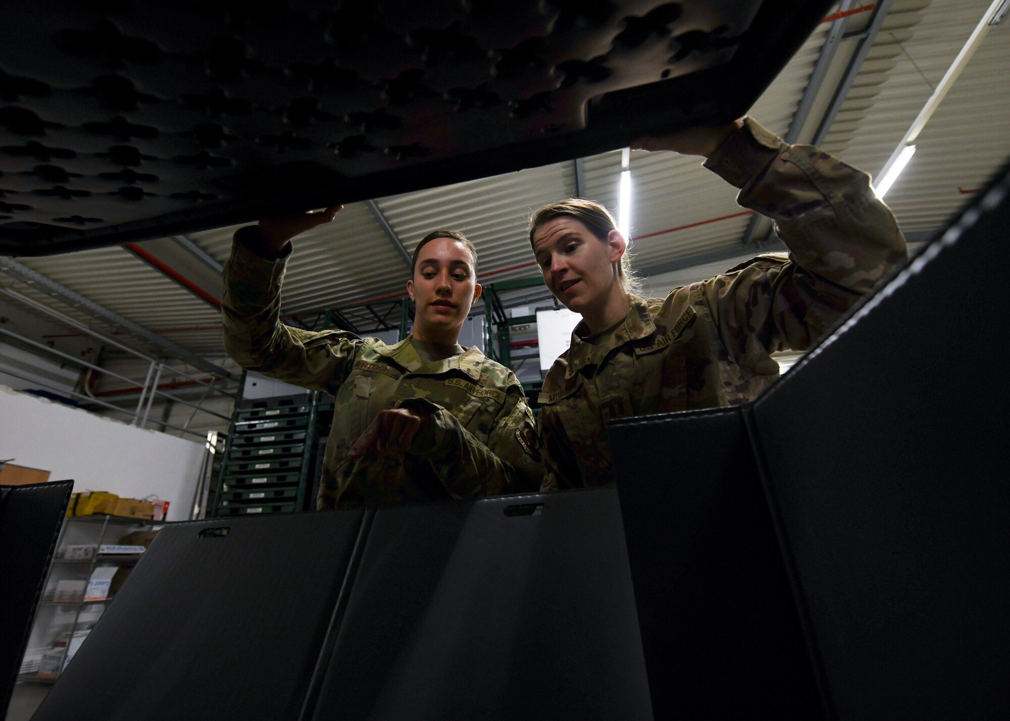 Capt. Christine Morshed, 435th Air Expeditionary Wing surgeon general office lead and medical service corps officer, right, and Tech. Sgt. Alicia Bertoch, 435th AEW surgeon general office flight chief, look inside a war reserve materiel package at Ramstein Air Base, Germany, Sept. 22, 2020. The SG office was created for the wing in 2019 and is vital for medical personnel throughout Africa to receive supplies and equipment because they have the ability to send shipments downrange faster utilizing local military aircraft. (U.S. Air Force photo by Senior Airman Madeline Herzog)