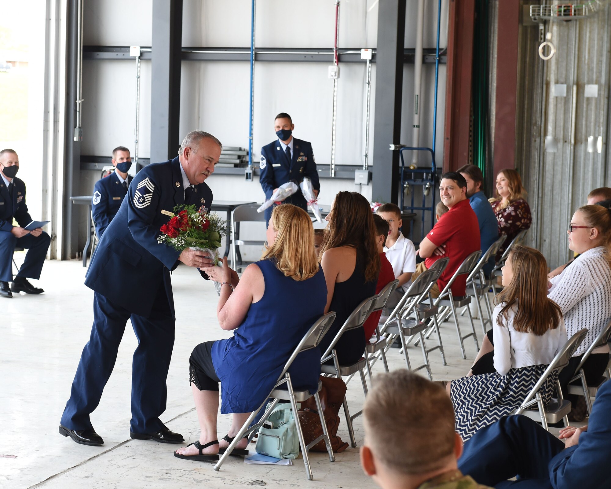 Chief Master Sgt. Timothy Whisler, 132d Fire and Emergency Services chief, gives flowers to his wife Terri during his retirement ceremony September 19, 2020 at the 132d Wing in Des Moines, Iowa. Whisler been a firefighter since 1979. (U.S. Air National Guard photo by Tech. Sgt. Michael J. Kelly