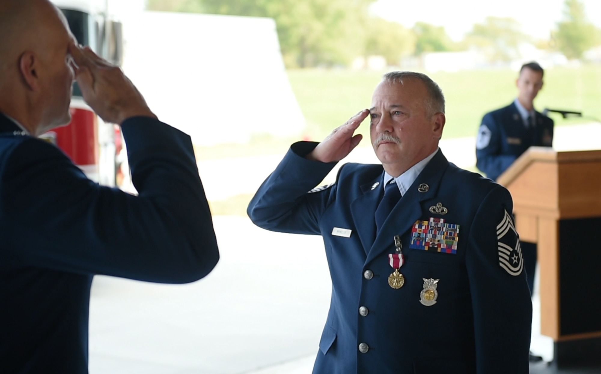 Chief Master Sgt. Timothy Whisler, 132d Fire and Emergency Services chief, salutes his commander Lt. Col. Robert Devens during his retirement ceremony September 19, 2020 at the 132d Wing in Des Moines, Iowa. Whisler  received the Meritorious Service Medal with two oak leaf clusters during the ceremony. (U.S. Air National Guard photo by Tech. Sgt. Michael J. Kelly)