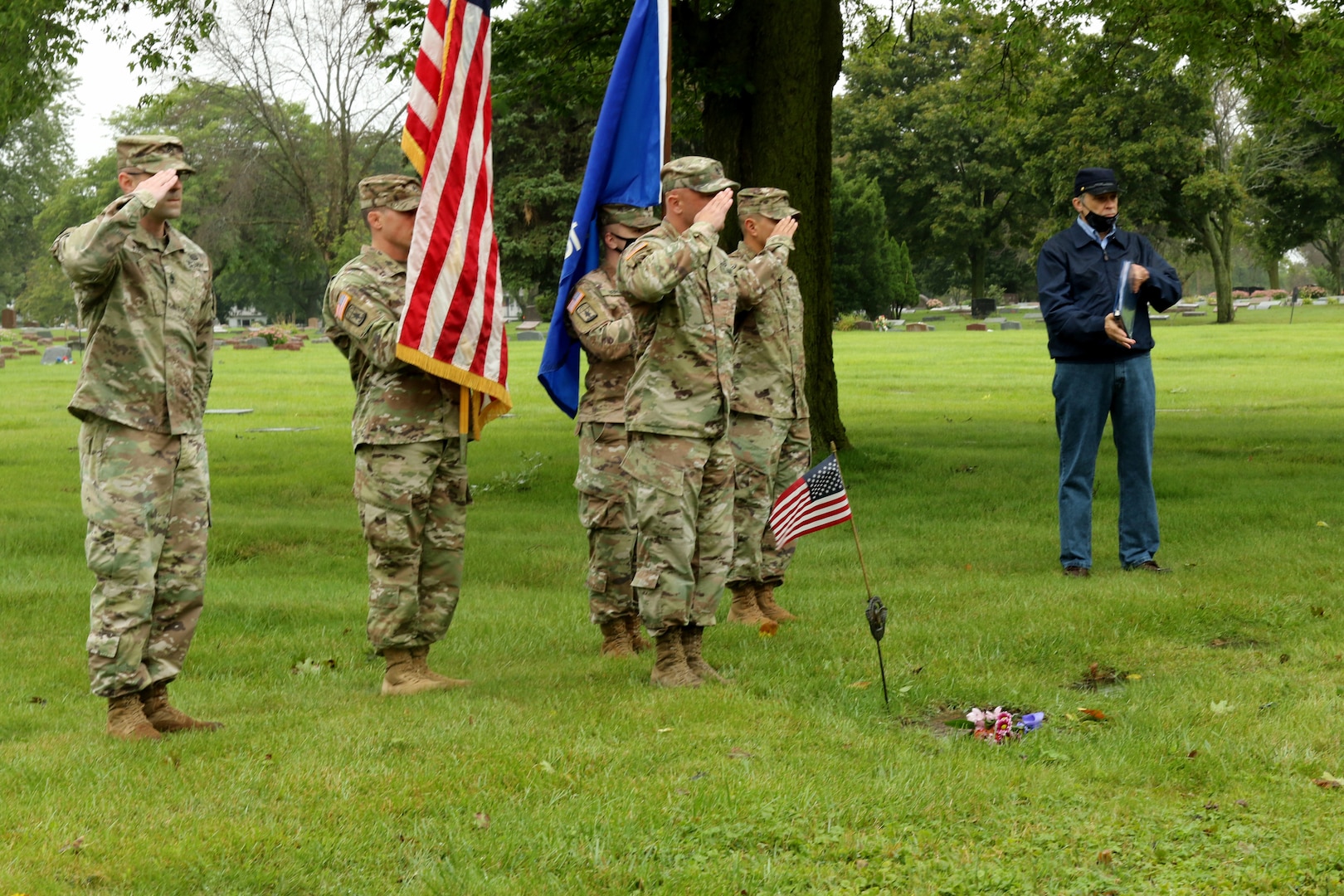 Members of a Wisconsin National Guard color guard with Battery C, 1st Battalion, 120th Field Artillery, salute during a headstone dedication ceremony for Staff Sgt. Walter A. Schaller Sept. 10, 2020, at Holy Cross Cemetery in Milwaukee. Schaller joined the Wisconsin Army National Guard's 32nd Division on April 29, 1941, and was killed in New Guinea on Feb. 20, 1944. He was buried in an unmarked grave at the cemetery in 1949 until a local historian discovered it through research.