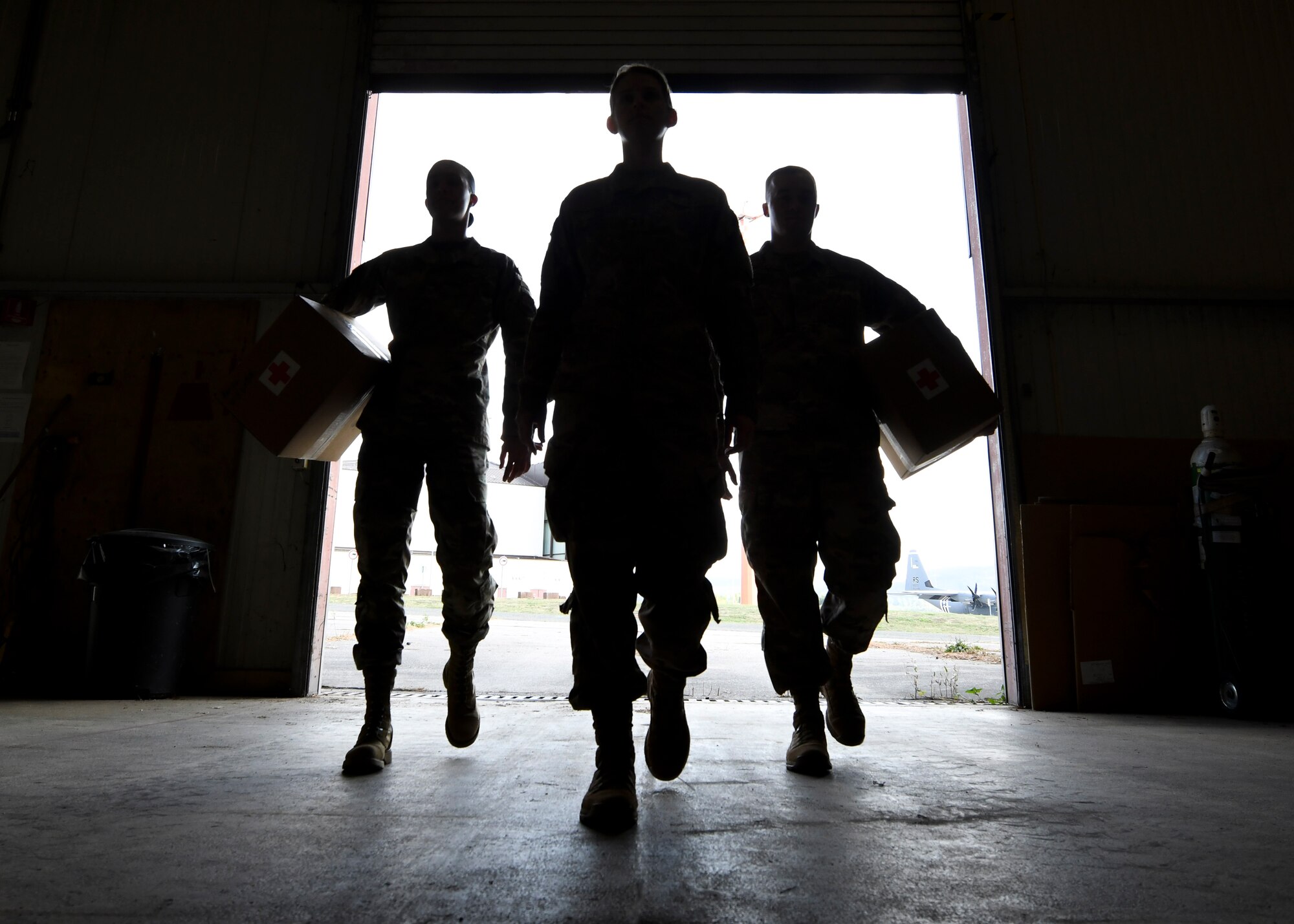 435th Air Expeditionary Wing Surgeon General Airmen walk into a warehouse at Ramstein Air Base, Germany, Sept. 22, 2020. The Surgeon General office has oversight of all medical operations conducted for the wing throughout Africa, and is the primary resource for medical personnel, supplies, maintenance and readiness. (U.S. Air Force photo by Senior Airman Madeline Herzog)
