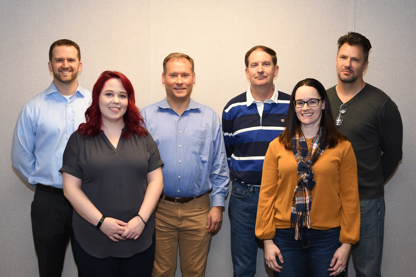 Six members of the Government Furnished Equipment Agnostic Software Team pose for a photo. The 20 member team received the Award of Merit for Group Achievement for their work to deliver quality software products for use in laser weapon systems. Team members include Teresa Berra, James Bohannon, Taylor Evelyn, David Fedorchak, Jr., Donald Fogler, Mark Glass, Kaela Gosdzinski, John Jahn, Thomas Lackert, Jr., James Latourell, Van Le, Jean Levy, Chris Meyer, Melissa Olson-Phipps, David Pritchett, Barry Ross, Eric Schroeder, Zachary Sherrod, Yong Shin, and Elliott Sperlazza. Pictured: FRONT ROW (left to right): Kaela Gosdzinski, Melissa Olson-Phipps BACK ROW (left to right): Eric Schroeder, Mark Glass, Jim Latourell, David Fedorchak Jr.