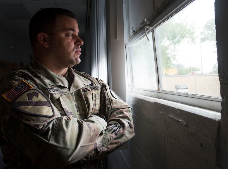 U.S. Army Sgt. 1st Class Corrie Ferrin, 1-210th Aviation Regiment senior instructor, stares out the window of his work center on Sept. 18, 2020 at Joint-Base Langley Eustis, Virginia. Ferrin was awarded Military Citizen of the Year by the Virginia Peninsula Chamber of Commerce. Ferrin was nominated for his volunteer efforts in taking care of Soldiers and their families during the COVID-19 pandemic. (U.S. Air Force photo by Staff Sgt. Joshua Magbanua)