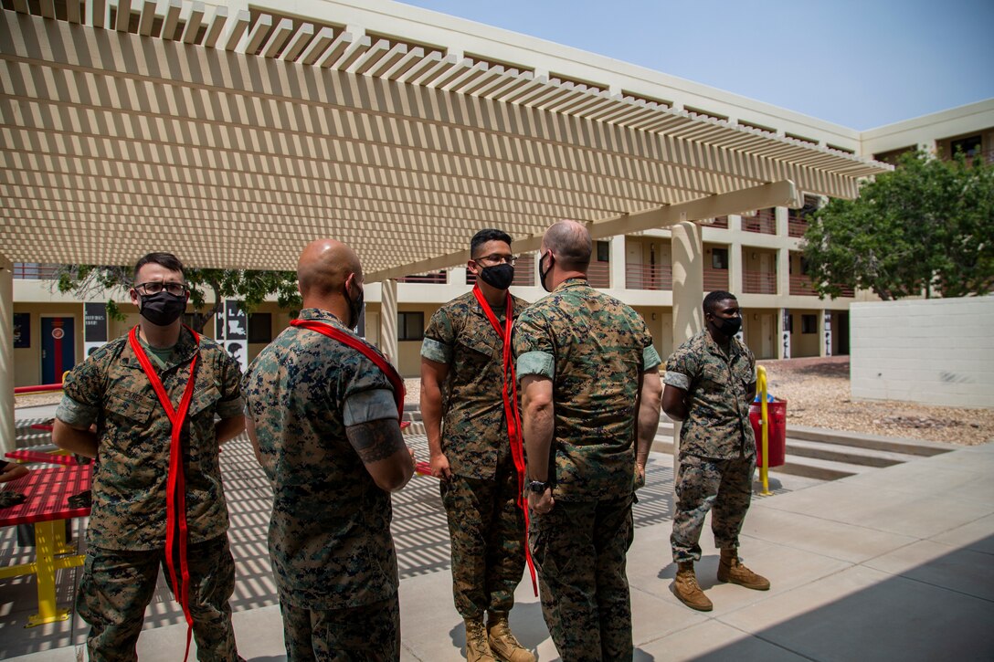 U.S. Marines assigned to Marine Corps Air Station (MCAS) Yuma, Headquarters and Headquarters Squadron (H&HS), receive their blood stripe during the H&HS Blood Stripe Ceremony at MCAS Yuma, Ariz., August 3, 2020.