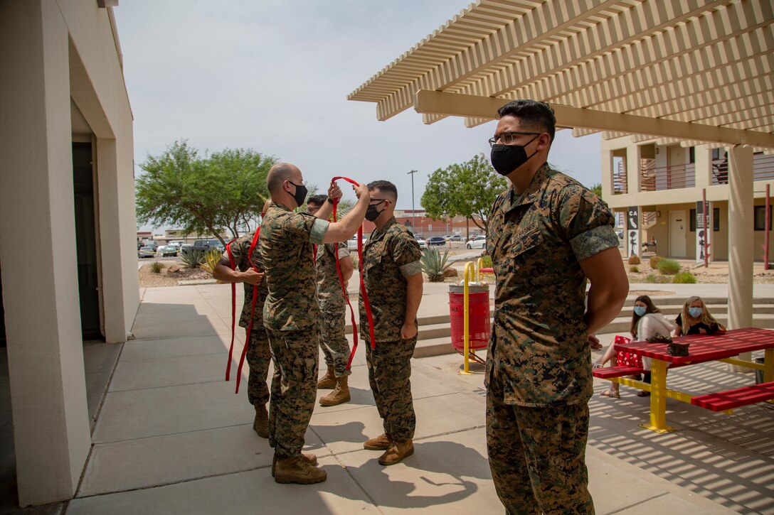 U.S. Marines assigned to Marine Corps Air Station (MCAS) Yuma, Headquarters and Headquarters Squadron (H&HS), receive their blood stripe during the H&HS Blood Stripe Ceremony at MCAS Yuma, Ariz., August 3, 2020.
