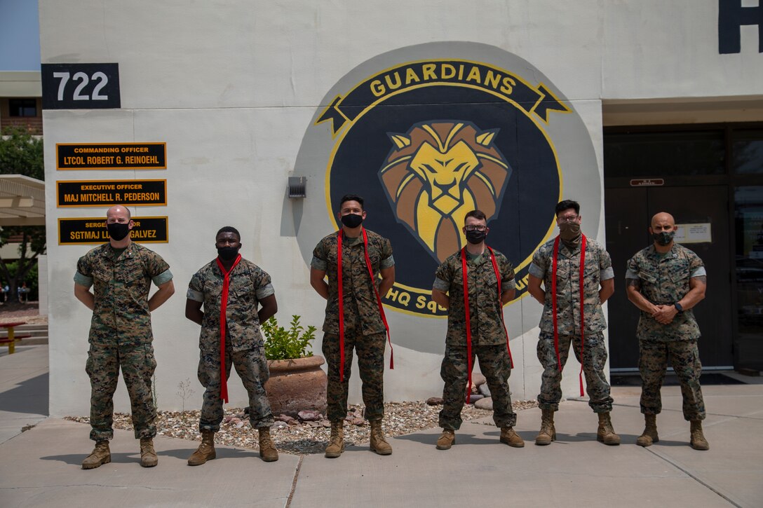 U.S. Marines assigned to Marine Corps Air Station (MCAS) Yuma, Headquarters and Headquarters Squadron (H&HS), receive their blood stripe during the H&HS Blood Stripe Ceremony at MCAS Yuma, Ariz., August 3, 2020.