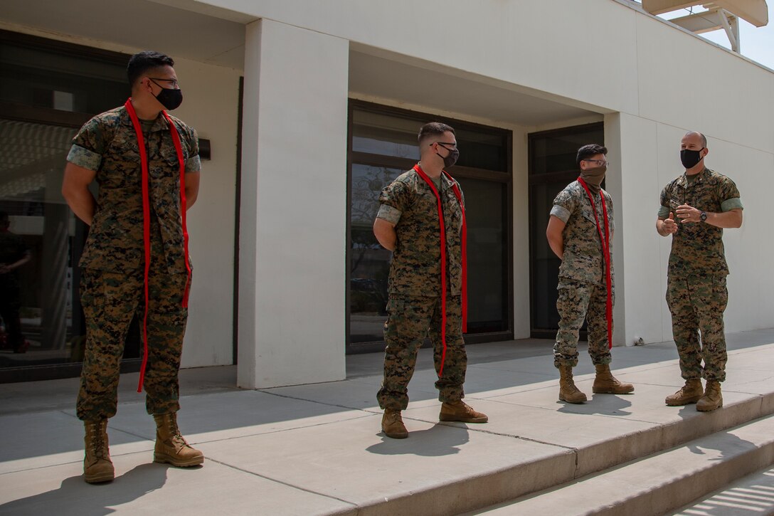 U.S. Marines assigned to Marine Corps Air Station (MCAS) Yuma, Headquarters and Headquarters Squadron (H&HS), receive their blood stripe during the H&HS Blood Stripe Ceremony at MCAS Yuma, Ariz., August 3, 2020.