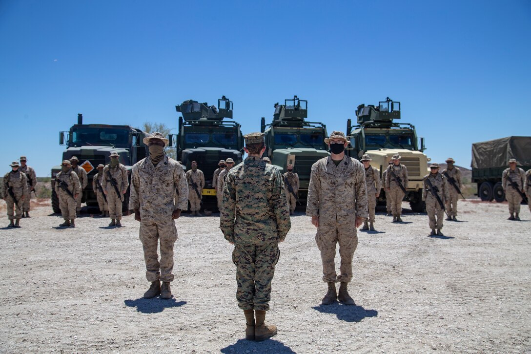 U.S. Navy Hospital Corpsmen (HM) 3 Ayite Akypokli and HM2 Courtland Morris, field medical service technicians, attached to Marine Air Control (MACS) 1 receive their Enlisted Fleet Marine Force (FMF) Warfare Specialist Insignia award at Yuma Proving Grounds (YPG) aboard Marine Corps Air Station Yuma, Aug. 6, 2020.