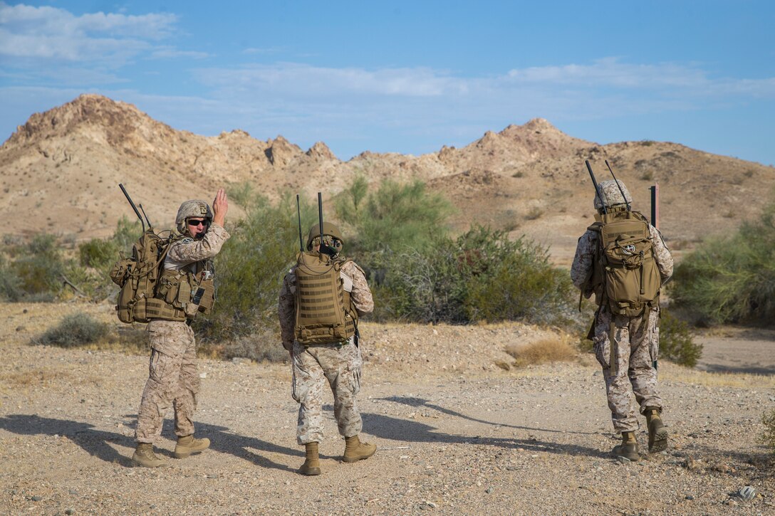 U.S. Marines with Marine Aviation Weapons and Tactics Squadron (MAWTS) 1 hike to an observation point during a live ordnance observation training in Yuma, Ariz., Aug. 28, 2020.