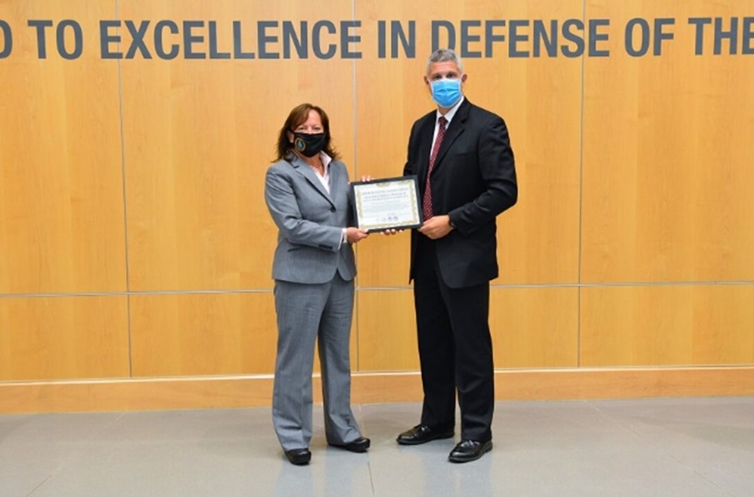 DIA's Office of Security Director Jeanette Courtney (left) received the full operating capability certificate from the National Insider Threat Task Force Director Charlie Margiotta in a small ceremony last week at DIA Headquarters. (Photos by Ally Rogers, DIA Public Affairs)