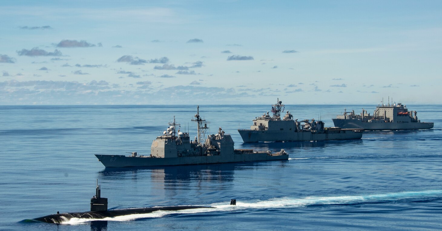 PHILIPPINE SEA (Sept. 25, 2020) USS Chicago (SSN 721), front, USS Shiloh (CG 67), USS Comstock (LSD 45), USNS Sacagawea (T-AKE 2) and USNS Charles Drew (T-AKE 10) steam in formation with the Navy’s only forward-deployed aircraft carrier USS Ronald Reagan (CVN 76), in support of Valiant Shield 2020. Valiant Shield is a U.S. only, biennial field training exercise (FTX) with a focus on integration of joint training in a blue-water environment among U.S. forces. This training enables real-world proficiency in sustaining joint forces through detecting, locating, tracking and engaging units at sea, in the air, on land and in cyberspace in response to a range of mission areas. (U.S. Navy video by Mass Communication Specialist 2nd Class Erica Bechard)