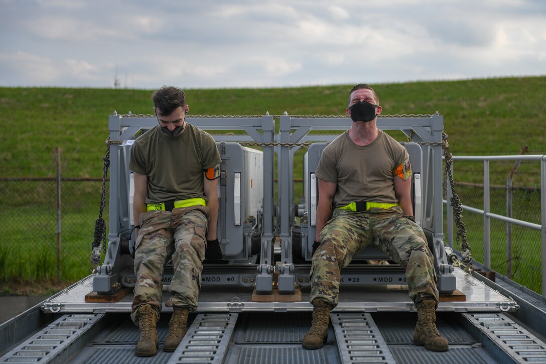 Special handling Airmen push Aegis missiles onto highline docks