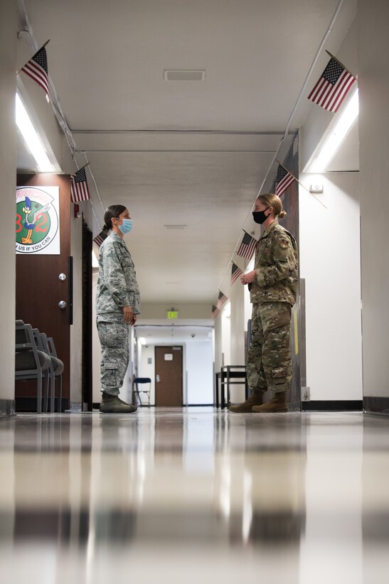 Reserve mental health team member Maj. Mayara Coulter (left) confers with a cadet.