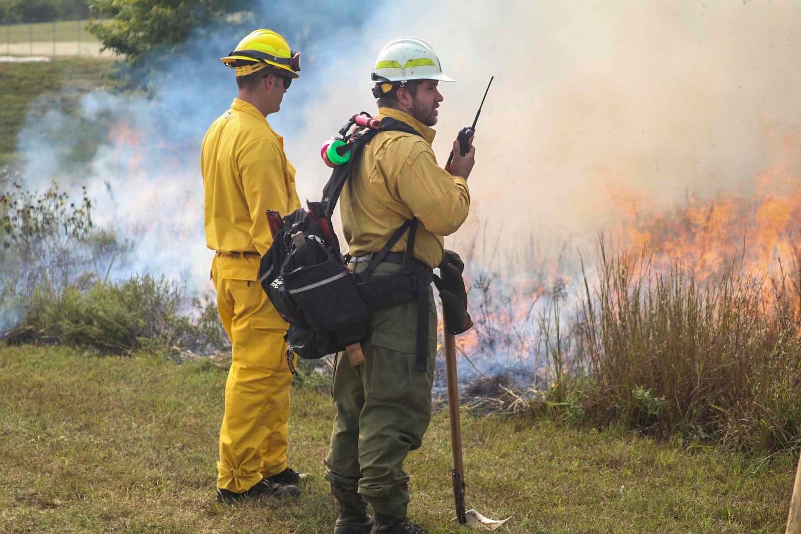 Chris Hanson, right, district fire management officer with the Kansas Forest Service, monitors a controlled burn with a Kansas National Guard student during the Wildland Firefighting Red Card Certification Course at the Great Plains Regional Training Center in Salina Sept. 17, 2020.