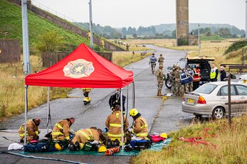 Airmen and firefighters from the 501st Combat Support Wing, respond to a crime scene during an exercise at RAF Molesworth, England, Sept. 23, 2020. The exercise tested Airmen and firefighter’s preparedness and interoperability by responding to a simulated drone ordinance attack. (U.S. Air Force photo by Senior Airman Eugene Oliver)