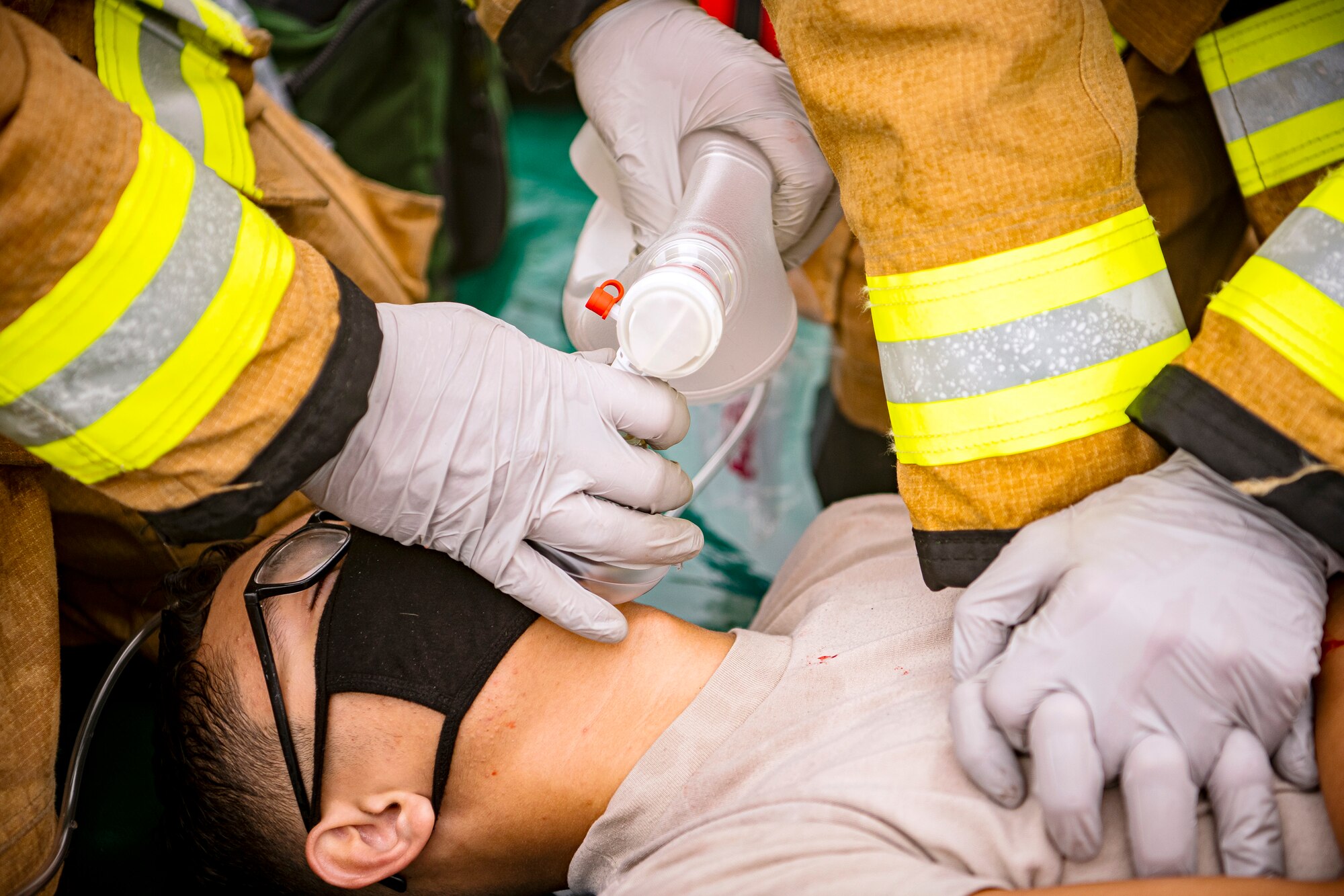 Firefighters from the 423rd Civil Engineer Squadron, tend to a simulated victim during an exercise at RAF Molesworth, England, Sept. 23, 2020. The exercise tested Airmen and firefighter’s preparedness and interoperability by responding to a simulated drone ordinance attack. (U.S. Air Force photo by Senior Airman Eugene Oliver)