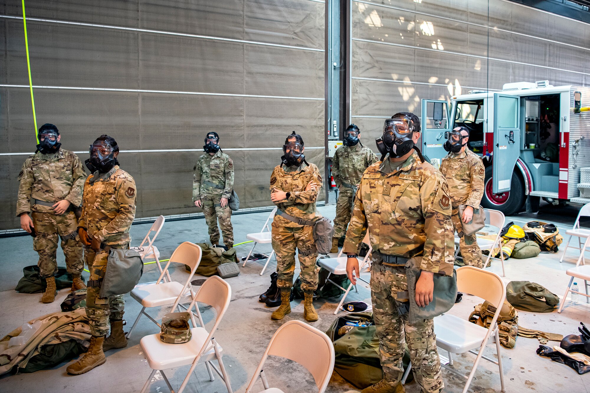 Airmen from the 501st Combat Support Wing listen to a briefing during a Chemical, Biological, Radiological, Nuclear and Explosives class at RAF Alconbury, England, Sept. 22, 2020. The 501st CSW conducted an exercise to test Airmen’s preparedness and interoperability by training them to combat enemy attacks while also familiarizing them with mission-oriented protective posture (MOPP) gear. (U.S. Air Force photo by Senior Airman Eugene Oliver)
