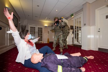 U.S. Air Force Senior Airman Sergio Miranda, right, 422nd Security Forces Squadron response force member, and other security forces members, enter a building in response to a simulated attack call during an exercise at RAF Croughton, England, Sept. 22, 2020. The 501st Combat Support Wing exercise tested preparedness and interoperability by responding to a simulated active stabber situation. (U.S. Air Force photo by Senior Airman Jennifer Zima)