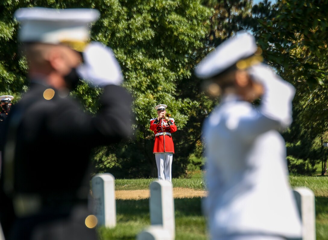 Master Gunnery Sgt. Matthew Harding, trumpeter, “The President’s Own” U.S. Marine Band, plays “Taps” during a full honors funeral for repatriated WWII Marine Pfc. Harry Morrissey at Arlington National Cemetery, Arlington, Virginia, Sept. 22, 2020.