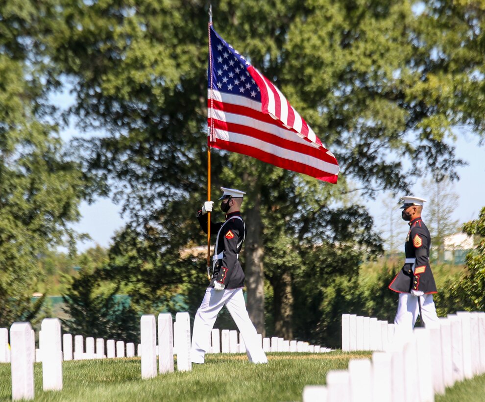 Lance Cpl. Joshua Murphy, flag bearer, the Official U.S. Marine Corps Color Guard, marches with the National Ensign during a full honors funeral for repatriated WWII Marine Pfc. Harry Morrissey at Arlington National Cemetery, Arlington, Virginia, Sept. 22, 2020. Morrissey, a Everett, Massachusetts native, was killed in action while participating in the main offensive of the Battle of Guadalcanal on October 9, 1942, while serving with Company B, 1st Battalion, 1st Marines, 1st Marine Division. His remains were found atop Hill 73 on August 28, 2017 and identified on December 17, 2017. (U.S. Marine Corps photo by Sgt. Robert Knapp/Released)