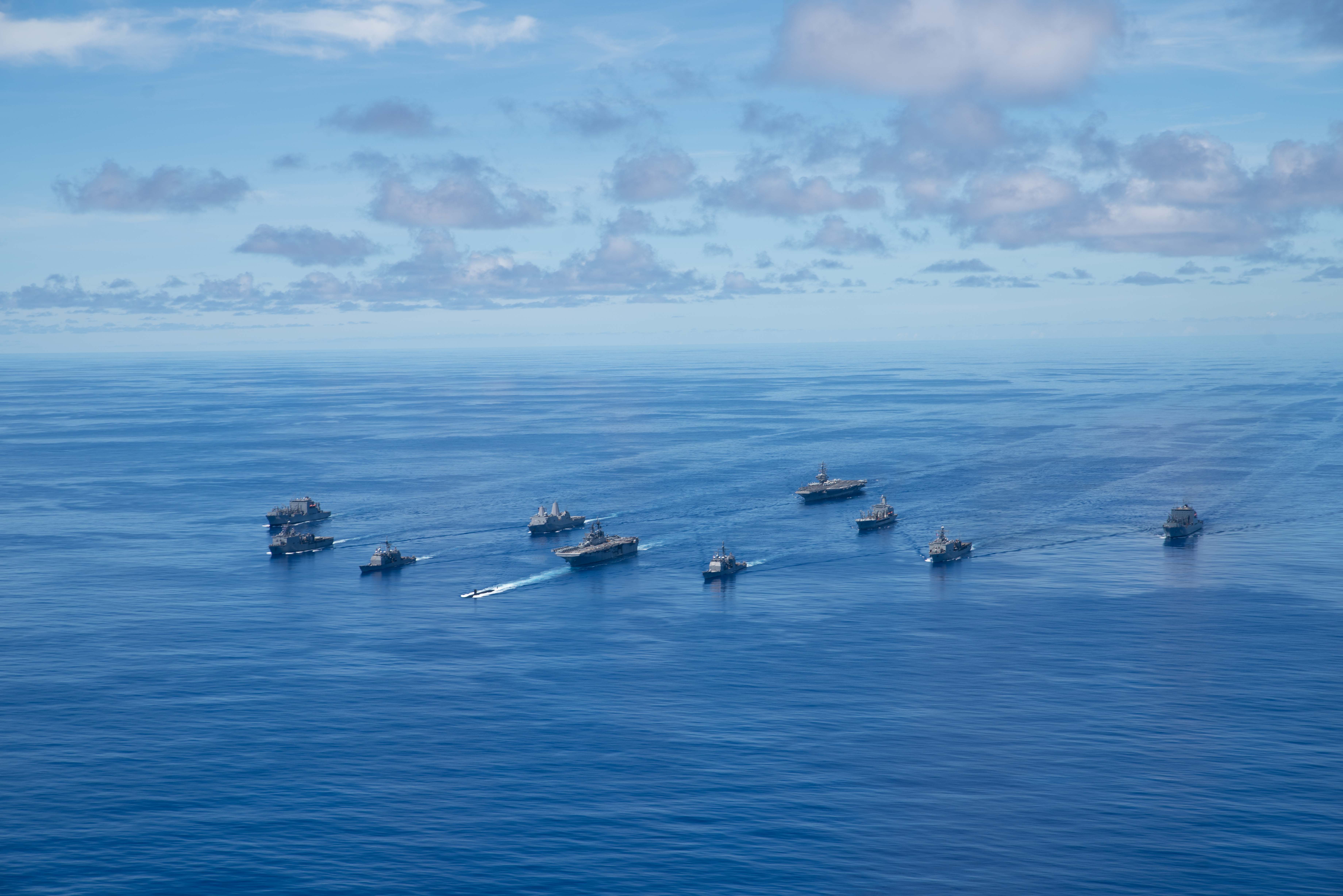 PHILIPPINE SEA (Sept. 25, 2020) From left, USNS Charles Drew (T-AKE 10), USS Comstock (LSD 45), USS Shiloh (CG 67), USS New Orleans (LPD 18), USS Chicago (SSN 721), USS America (LHA 6), USS Ronald Reagan (CVN 76), USNS John Ericsson (T-AO 194), USS Antietam (CG 54), USS Germantown (LSD 42), and USNS Sacagawea (T-AKE 2) steam in formation in support of Valiant Shield 2020. Valiant Shield is a U.S. only, biennial field training exercise (FTX) with a focus on integration of joint training in a blue-water environment among U.S. forces. This training enables real-world proficiency in sustaining joint forces through detecting, locating, tracking and engaging units at sea, in the air, on land and in cyberspace in response to a range of mission areas. (U.S. Navy photo by Mass Communication Specialist 3rd Class Jason Tarleton)