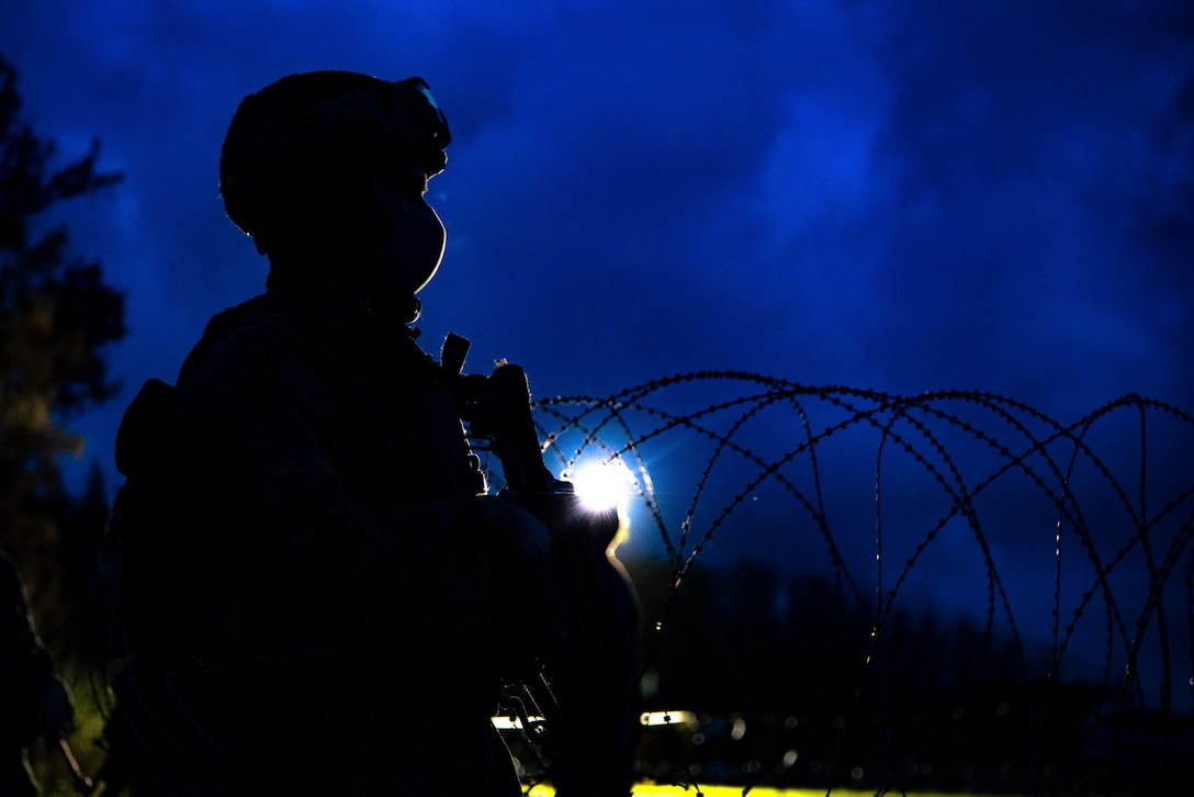 A U.S. Marine stands watch during a simulated embassy reinforcement at Kin Blue, Okinawa, Japan, Sept. 13.