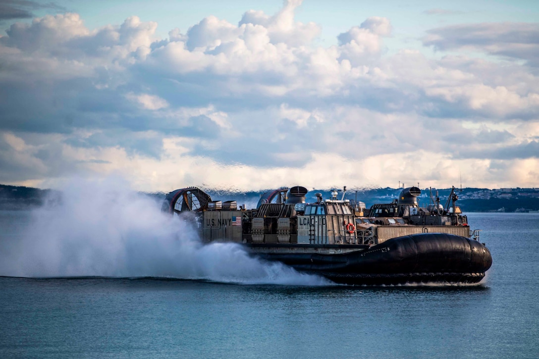 An air-cushioned landing craft travels through waters.