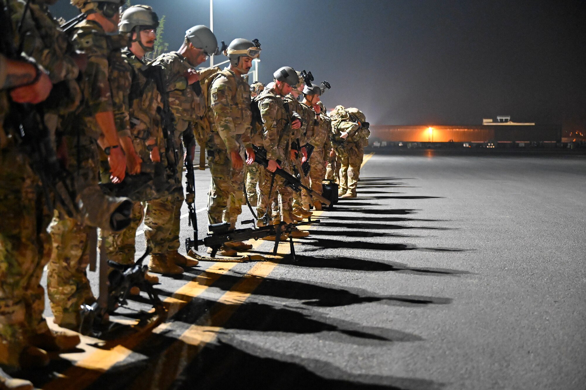 Soldiers stand in a line on the flightline