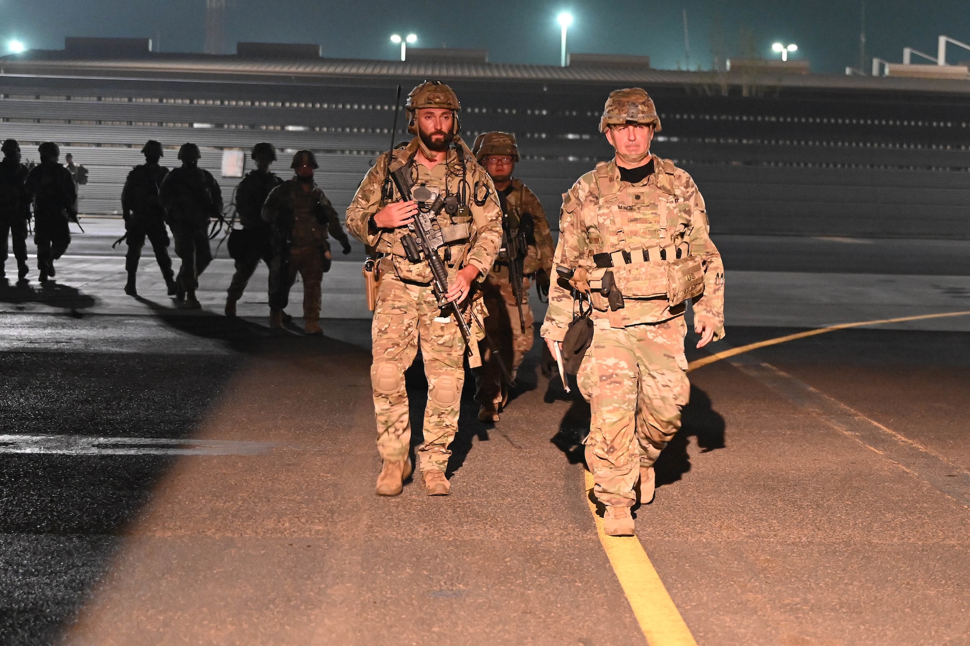 Soldiers walk on the flightline