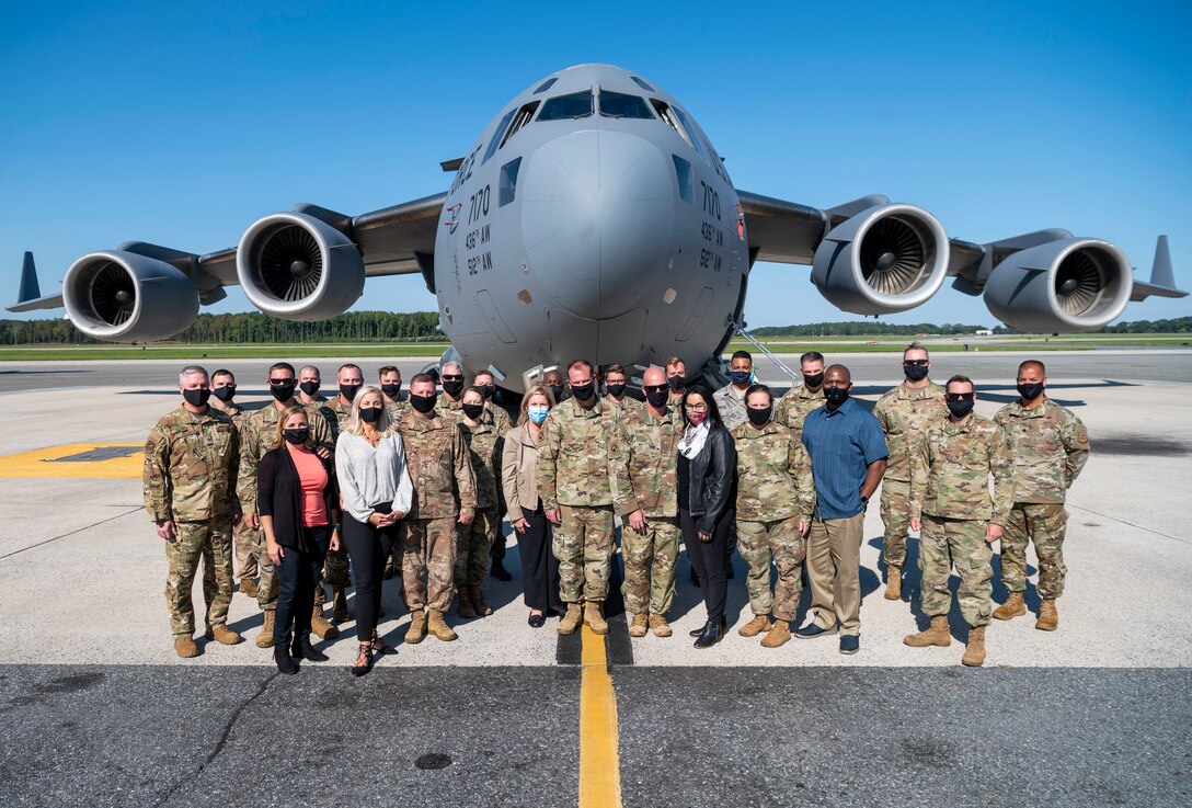 Leaders from the 18th Air Force and 436th Airlift Wing, along with spouses, pose for a group photo in front of a static C-17 Globemaster III at Dover Air Force Base, Delaware, Sept. 22, 2020. As Air Mobility Command’s sole numbered air force, 18th Air Force ensures the readiness and sustainment of approximately 36,000 active duty, Air Force Reserve and civilian Airmen at 12 wings and one stand-alone group. (U.S. Air Force photo by Senior Airman Christopher Quail)