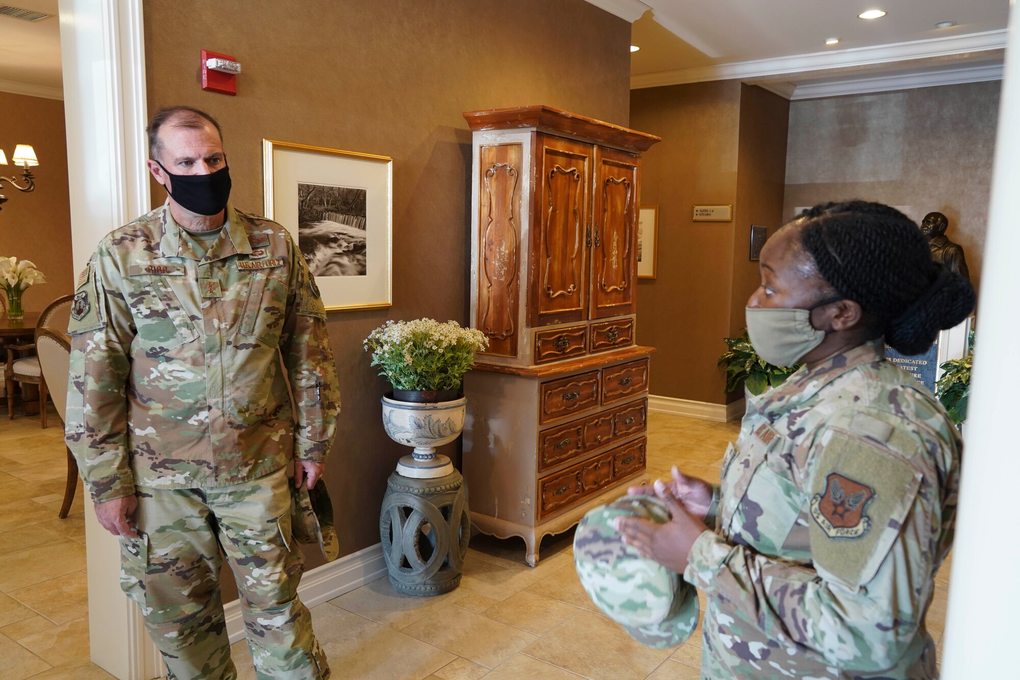 Maj. Gen. Thad Bibb, 18th Air Force commander, is briefed at the Fisher House for Families of the Fallen by Tech. Sgt. Michelle Johnson, Air Force Mortuary Affairs Operations Fisher House noncommissioned officer in charge, Dover Air Force Base, Delaware, Sept. 23, 2020. AFMAO Airmen highlighted their mission to the general and command chief during their visit to Dover. (U.S. Air Force photo by Tech. Sgt. Kaitlyn Maricle)