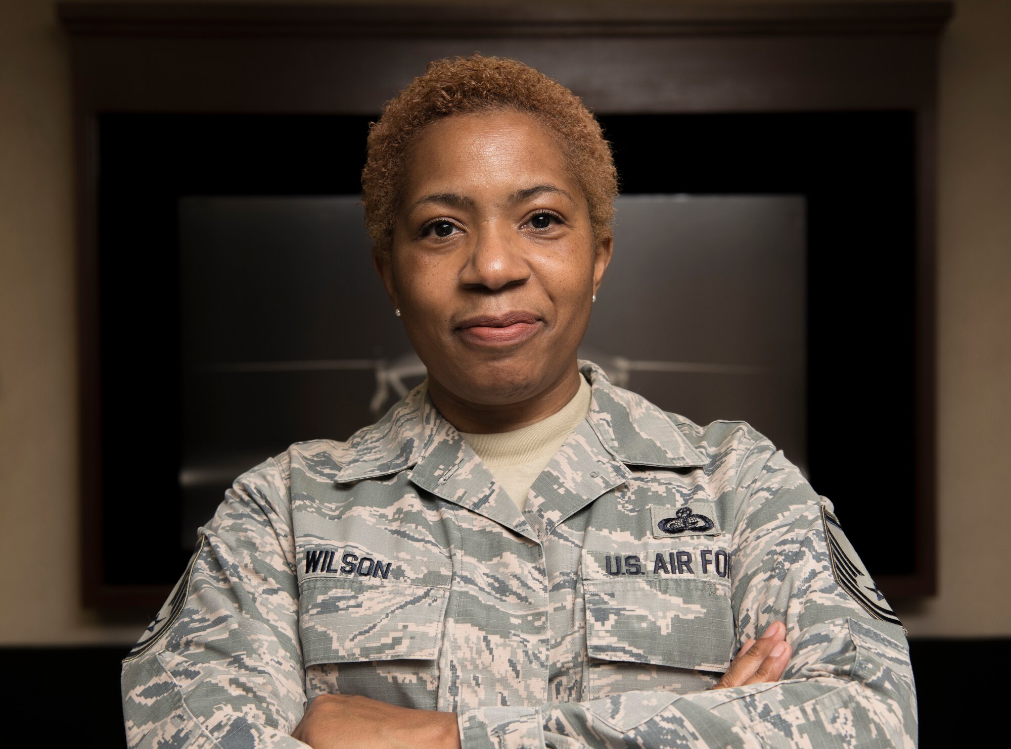 A female Airman smiles at the camera