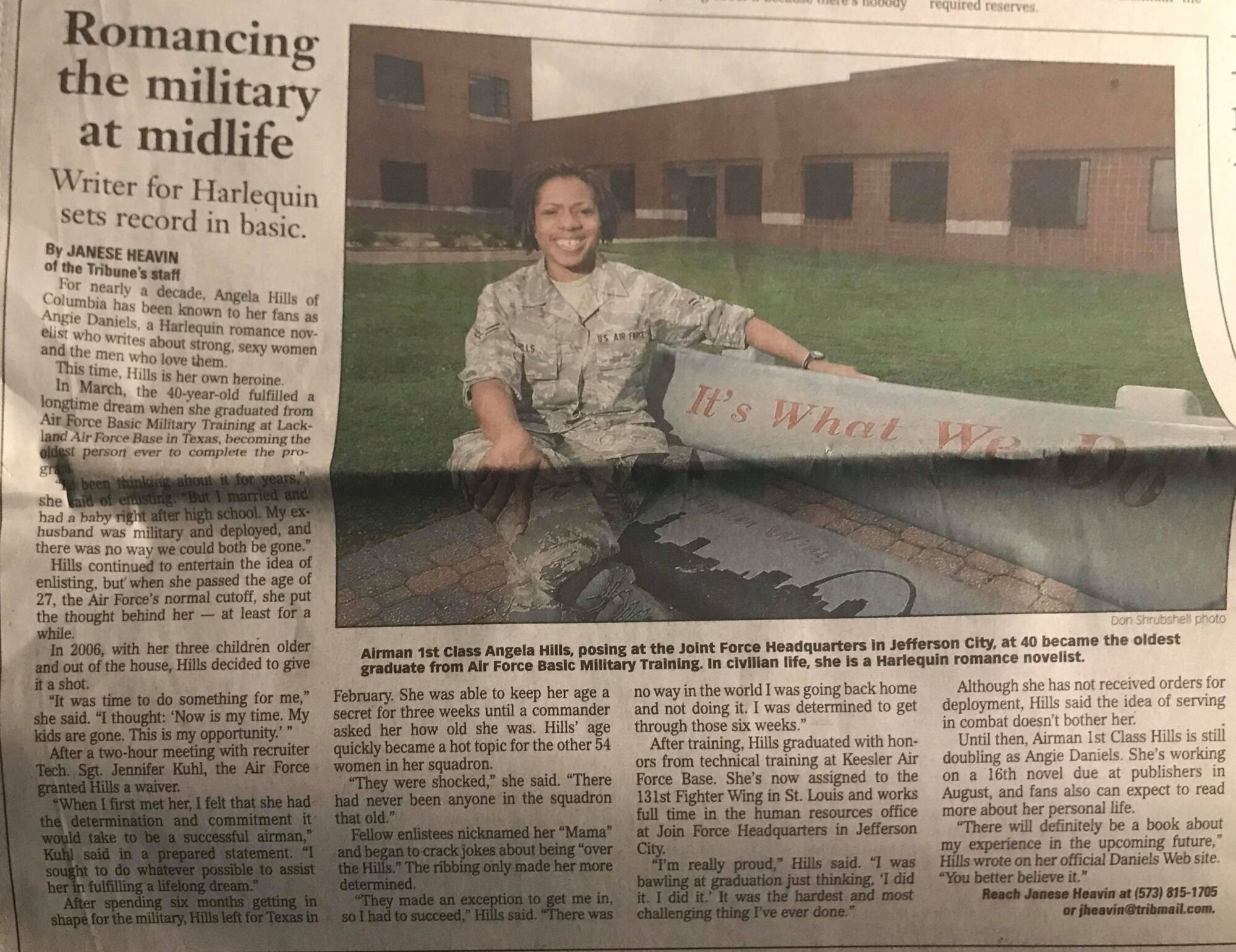 A newspaper article shows a female airman sitting on a bench
