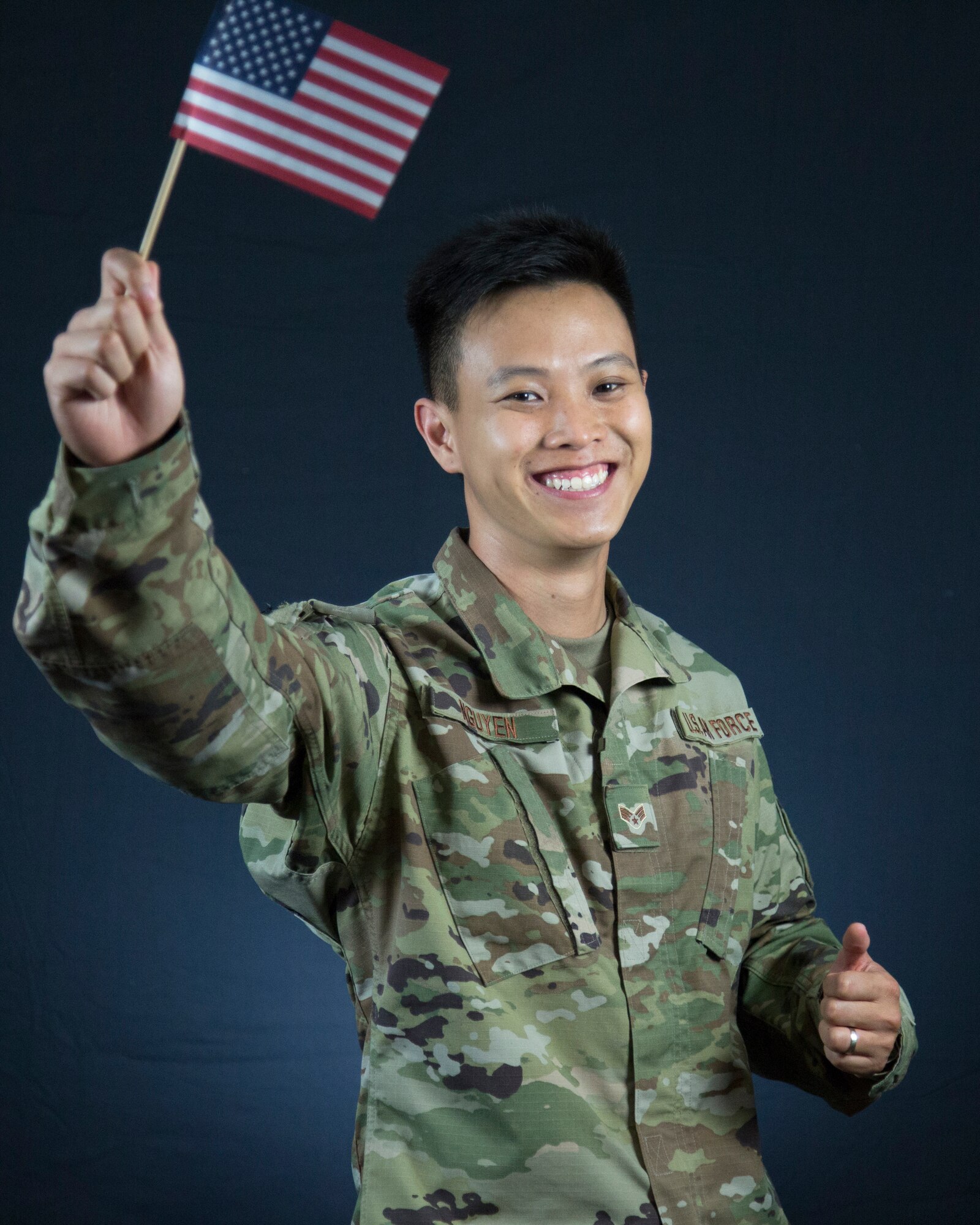 U.S. Air Force Senior Airman Huy X. Nguyen, 446th Force Support Squadron career development advisor, displays a U.S. flag on Joint Base Lewis-McChord, Washington, Aug. 28, 2020.