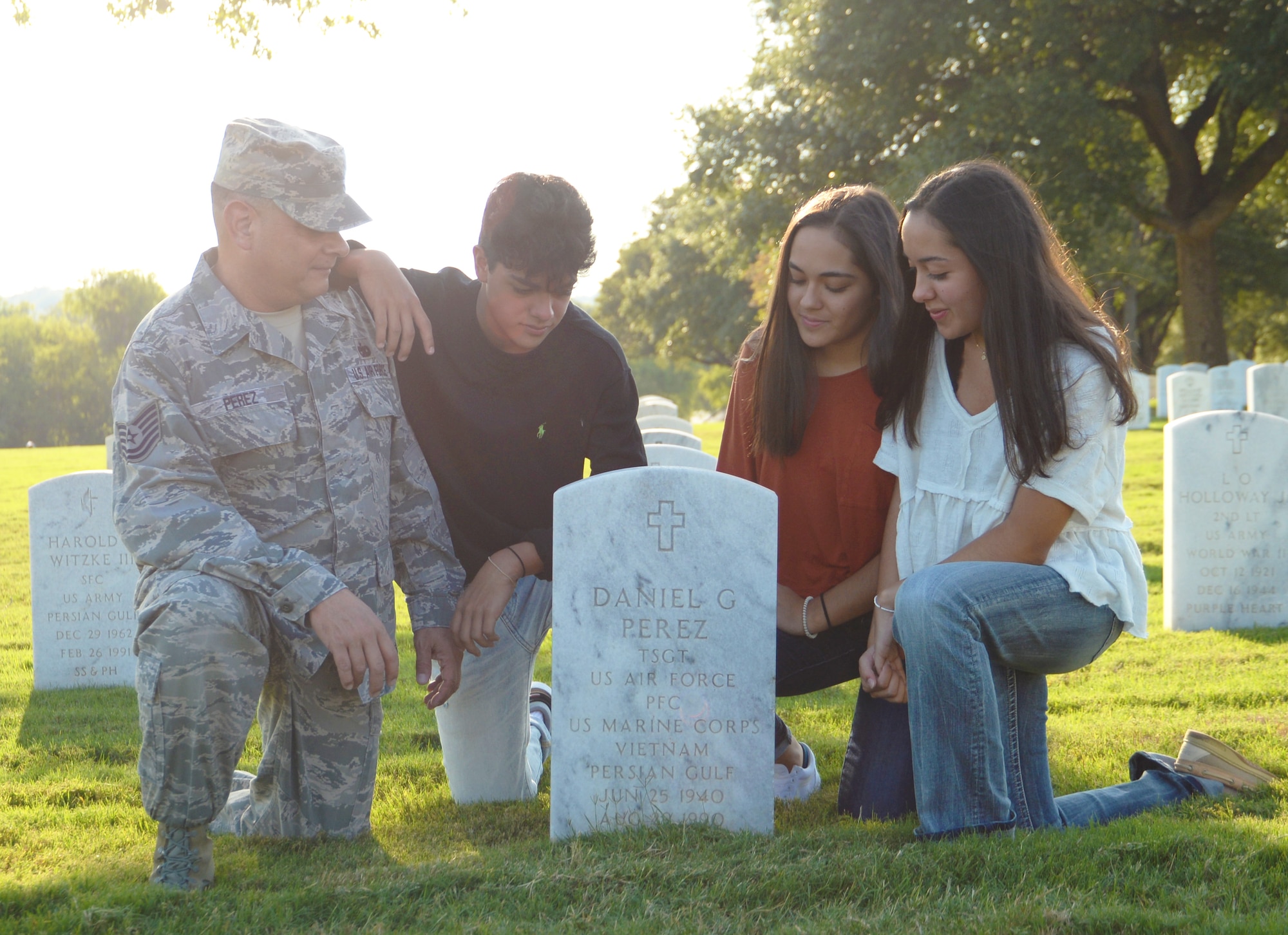 Tech. Sgt. Joseph Perez, 26th Aerial Port Squadron ramp services supervisor, visits the grave of his father Sept. 25, 2020, with his family at Fort Sam Houston Cemetery, San Antonio, Texas. (U.S. Air Force photo by Tech. Sgt. Samantha Mathison)