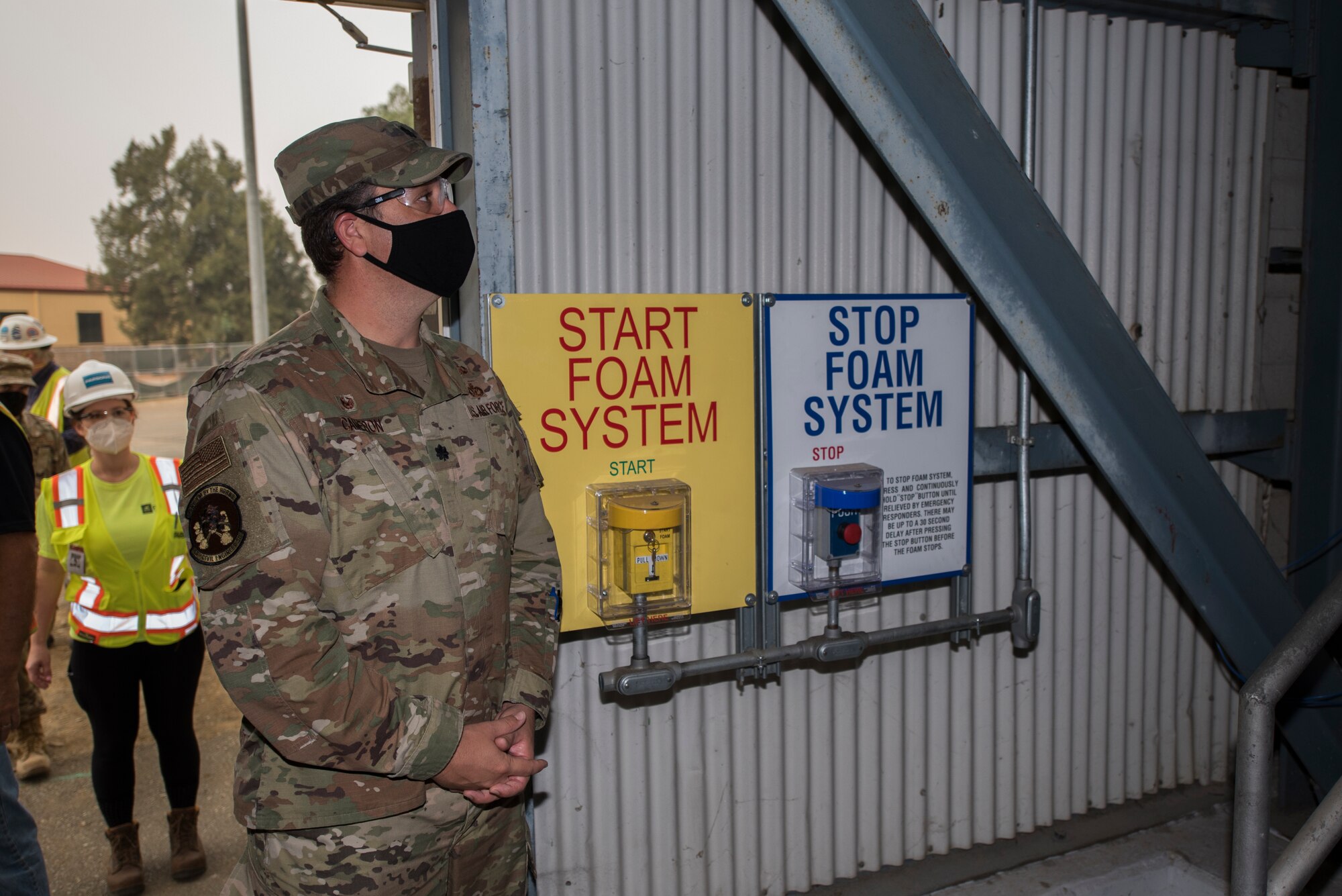 U.S. Air Force Lt. Col. Glenn Cameron, 60th Civil Engineering Squadron commander, waits for the countdown to trip the high expansion foam fire suppression system for a system test Sept. 11, 2020, at Travis Air Force Base, California. The system is used to extinguish fires inside aircraft hangars to protect Airmen and Air Force assets. (U.S. Air Force photo by Senior Airman Cameron Otte)
