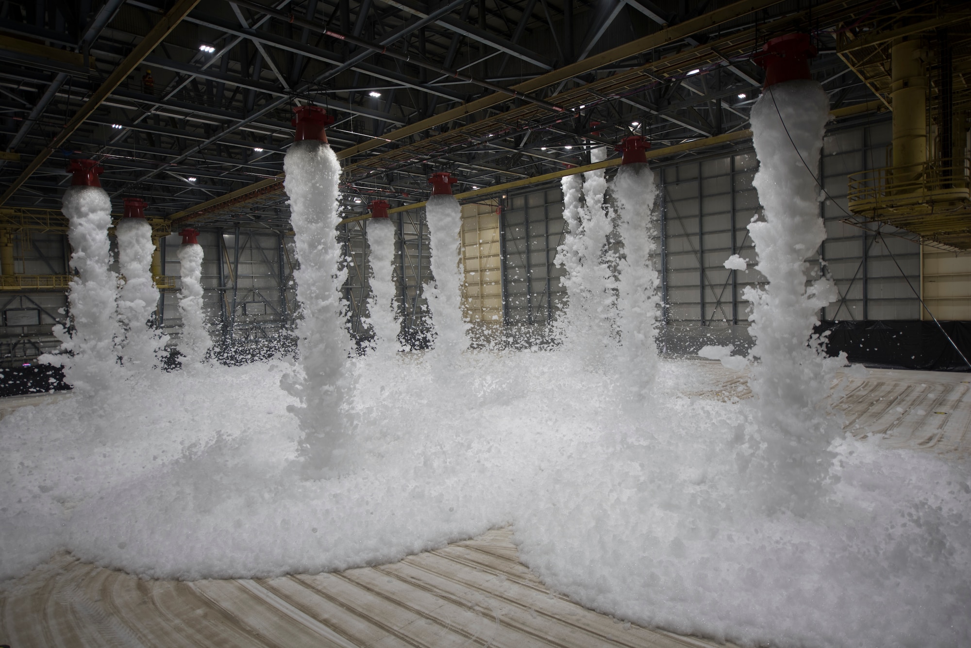 Hangar 811 fills with foam during a test of its high expansion foam fire suppression system Sept. 11, 2020, at Travis Air Force Base, California. The system is used to extinguish fires inside aircraft hangars to protect Airmen and Air Force assets. (U.S. Air Force photo by Senior Airman Cameron Otte)