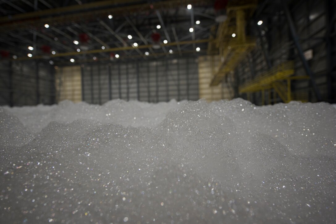 Foam fills Hangar 811 during a high expansion foam fire suppression system test Sept. 11, 2020, at Travis Air Force Base, California. The system is used to extinguish fires inside aircraft hangars to protect Airmen and Air Force assets. (U.S. Air Force photo by Senior Airman Cameron Otte)