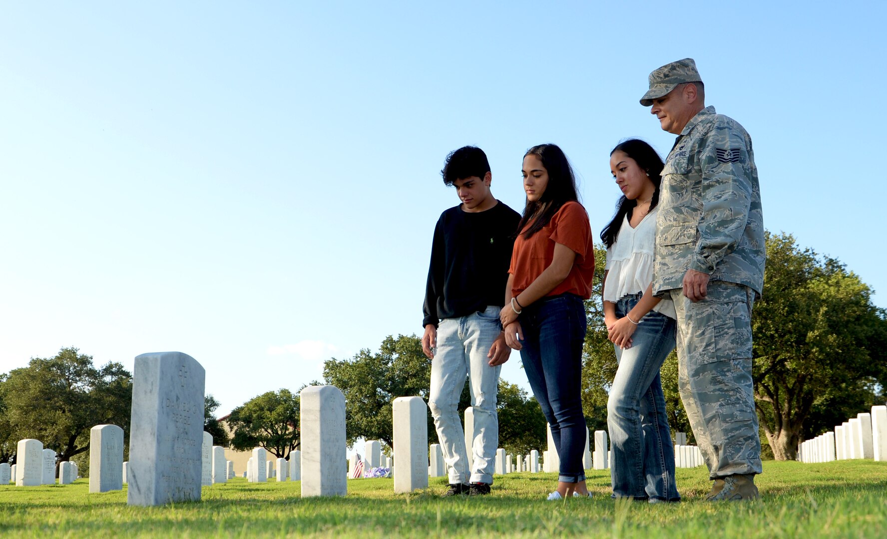 Tech. Sgt. Joseph Perez, 26th Aerial Port Squadron ramp services supervisor, visits the grave of his father Sept. 25, 2020, with his family at Fort Sam Houston Cemetery, San Antonio, Texas. (U.S. Air Force photo by Tech. Sgt. Samantha Mathison)