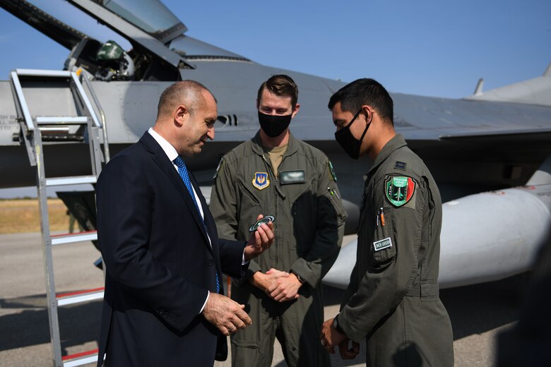 Rumen Radev, president of Bulgaria, left, receives a Triple Nickel squadron patch from two U.S. Air Force pilots assigned to the 555th Fighter Squadron during Thracian Viper 20 at Graf Ignatievo Air Base, Bulgaria, Sept. 24, 2020. Thracian Viper 20 is a multilateral training exercise with the Bulgarian air force, aimed to increase operational capacity, capability and interoperability with Bulgaria. (U.S. Air Force photo by Airman 1st Class Ericka A. Woolever)