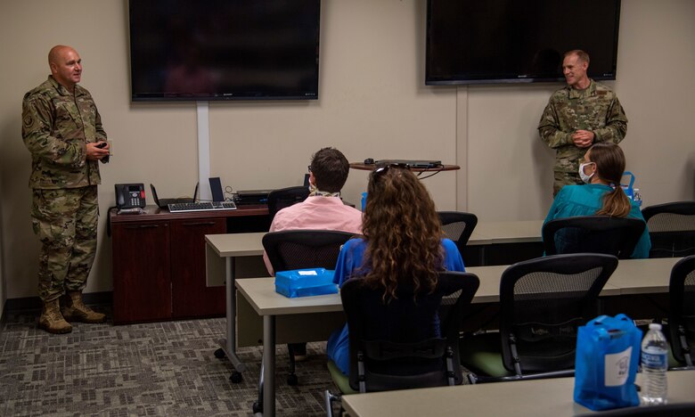 Air Force Chief Master Sgt. Anthony Green, left, 6th Air Refueling Wing (ARW) command chief and Col. Ben Jonsson, 6th ARW commander, right, speak to senior-leadership spouses during an immersion tour at MacDill Air Force Base, Florida, Sept. 24, 2020.