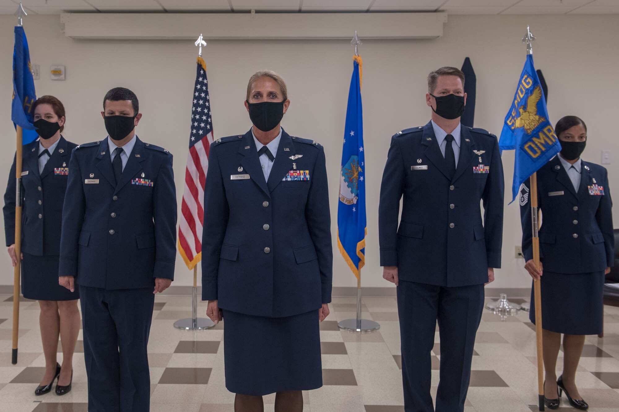 five Airmen stand during a ceremony