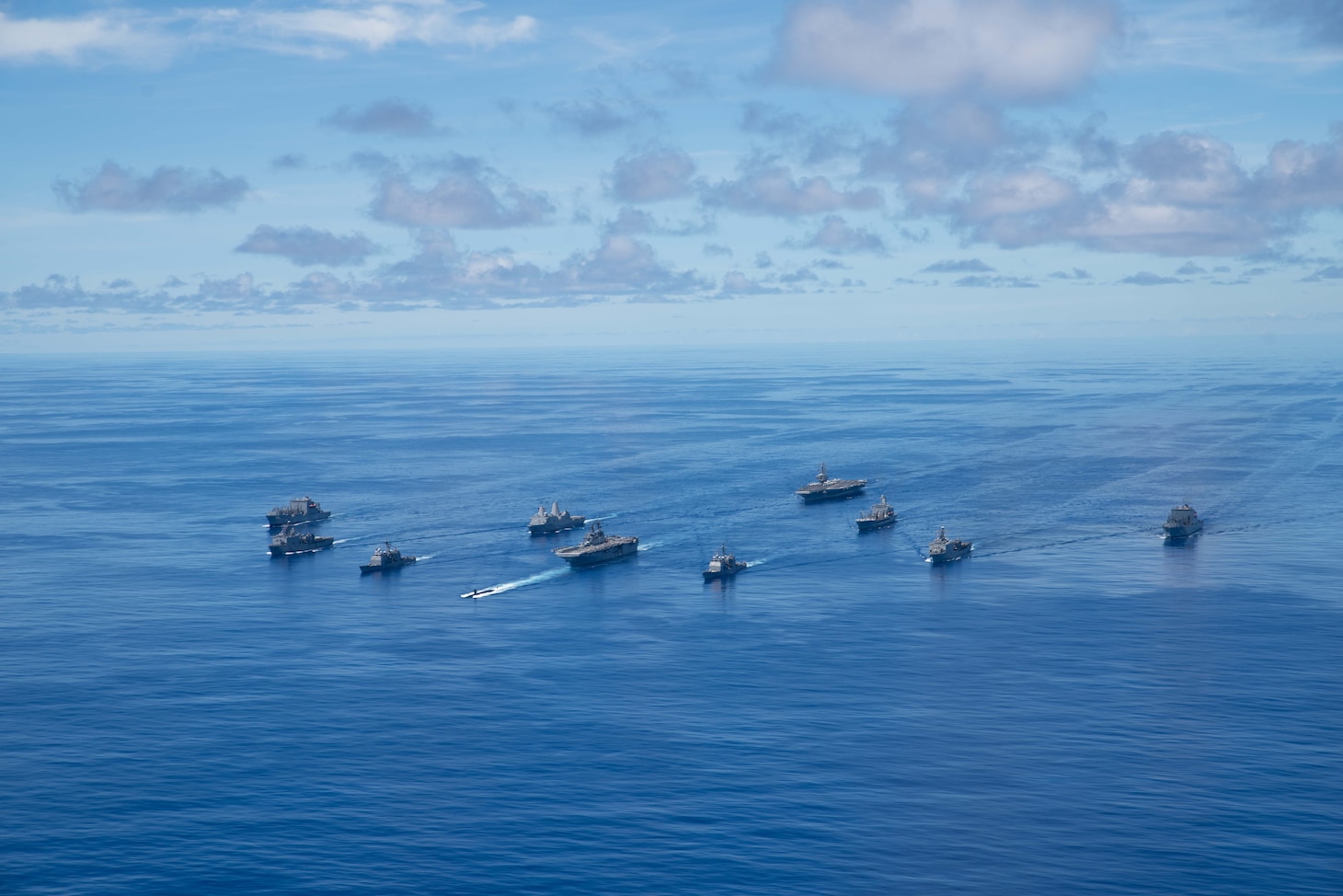 PHILIPPINE SEA (Sept. 25, 2020) From left, USNS Charles Drew (T-AKE 10), USS Comstock (LSD 45), USS Shiloh (CG 67), USS New Orleans (LPD 18), USS Chicago (SSN 721), USS America (LHA 6), USS Ronald Reagan (CVN 76), USNS John Ericsson (T-AO 194), USS Antietam (CG 54), USS Germantown (LSD 42), and USNS Sacagawea (T-AKE 2) steam in formation in support of Valiant Shield 2020. Valiant Shield is a U.S. only, biennial field training exercise (FTX) with a focus on integration of joint training in a blue-water environment among U.S. forces. This training enables real-world proficiency in sustaining joint forces through detecting, locating, tracking and engaging units at sea, in the air, on land and in cyberspace in response to a range of mission areas. (U.S. Navy photo by Mass Communication Specialist 3rd Class Jason Tarleton)