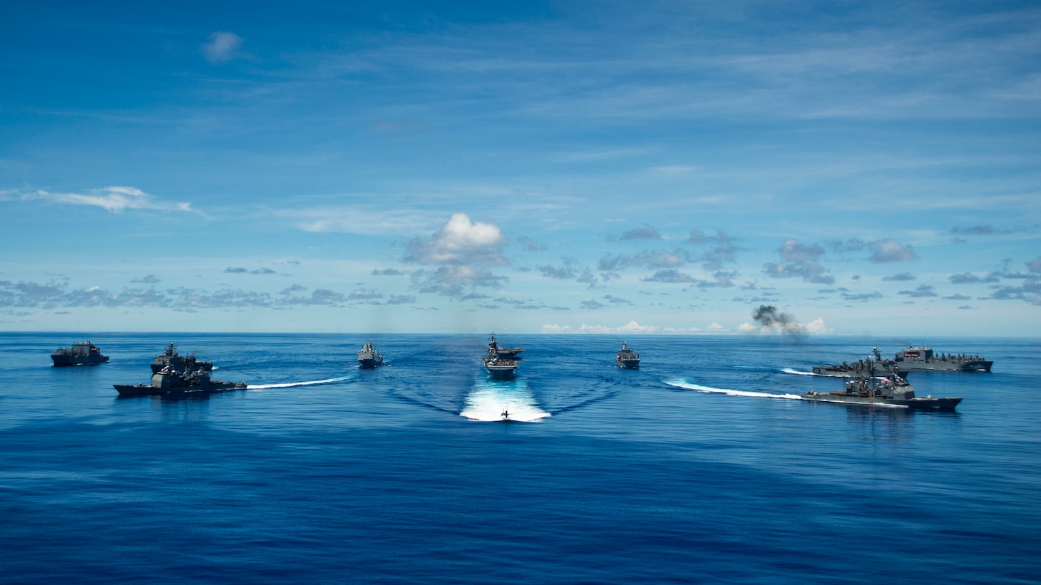 PHILIPPINE SEA (Sept. 25, 2020) From left, USNS Charles Drew (T-AKE 10), USS Comstock (LSD 45), USS Shiloh (CG 67), USS New Orleans (LPD 18), USS Chicago (SSN 721), USS America (LHA 6), USS Ronald Reagan (CVN 76), USNS John Ericsson (T-AO 194), USS Antietam (CG 54), USS Germantown (LSD 42), and USNS Sacagawea (T-AKE 2) steam in formation while E/A-18G Growlers and FA-18E Super Hornets from Carrier Air Wing (CVW) 5, a P-8 Poseidon from Commander Task Force 72, and U.S. Air Force F-22 Raptors and a B-1B Bomber fly over the formation in support of Valiant Shield 2020. Valiant Shield is a U.S. only, biennial field training exercise (FTX) with a focus on integration of joint training in a blue-water environment among U.S. forces. This training enables real-world proficiency in sustaining joint forces through detecting, locating, tracking and engaging units at sea, in the air, on land and in cyberspace in response to a range of mission areas. (U.S. Navy photo by Mass Communication Specialist 2nd Class Codie Soule)