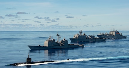 PHILIPPINE SEA (Sept. 25, 2020) USS Chicago (SSN 721), front, USS Shiloh (CG 67), USS Comstock (LSD 45), USNS Sacagawea (T-AKE 2) and USNS Charles Drew (T-AKE 10) steam in formation with the Navy’s only forward-deployed aircraft carrier USS Ronald Reagan (CVN 76), in support of Valiant Shield 2020. Valiant Shield is a U.S. only, biennial field training exercise (FTX) with a focus on integration of joint training in a blue-water environment among U.S. forces. This training enables real-world proficiency in sustaining joint forces through detecting, locating, tracking and engaging units at sea, in the air, on land and in cyberspace in response to a range of mission areas. (U.S. Navy video by Mass Communication Specialist 2nd Class Erica Bechard)
