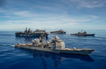 PHILIPPINE SEA (Sept. 25, 2020) USS Shiloh (CG 67), front, USS America (LHA 6), USS Antietam (CG 54), USS Germantown (LSD 42) and USNS Sacagawea (T-AKE 2), steam in formation with the Navy’s only forward-deployed aircraft carrier USS Ronald Reagan (CVN 76), in support of Valiant Shield 2020. Valiant Shield is a U.S. only, biennial field training exercise (FTX) with a focus on integration of joint training in a blue-water environment among U.S. forces. This training enables real-world proficiency in sustaining joint forces through detecting, locating, tracking and engaging units at sea, in the air, on land and in cyberspace in response to a range of mission areas. (U.S. Navy video by Mass Communication Specialist 2nd Class Erica Bechard)