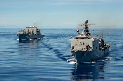 PHILIPPINE SEA (Sept. 25, 2020) USS Comstock (LSD 45), right, and USNS Charles Drew (T-AKE 10) steam in formation with the Navy’s only forward-deployed aircraft carrier USS Ronald Reagan (CVN 76), in support of Valiant Shield 2020. Valiant Shield is a U.S. only, biennial field training exercise (FTX) with a focus on integration of joint training in a blue-water environment among U.S. forces. This training enables real-world proficiency in sustaining joint forces through detecting, locating, tracking and engaging units at sea, in the air, on land and in cyberspace in response to a range of mission areas. (U.S. Navy video by Mass Communication Specialist 2nd Class Erica Bechard)