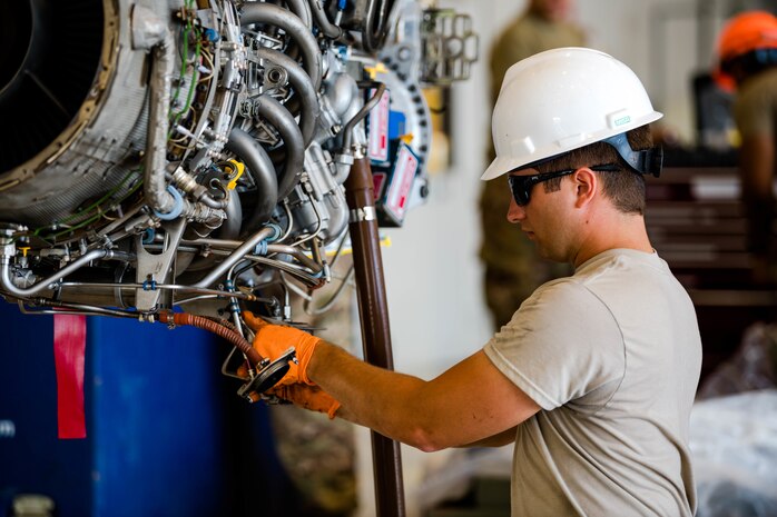 Staff Sgt. Benjamin Hetzel connects hoses on a C-146A engine as part of routine maintenance. (Dan Maffett)